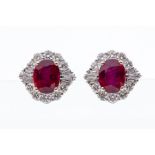 A pair of ruby and diamond 18ct white gold cluster earrings, comprising central claw set rubies,