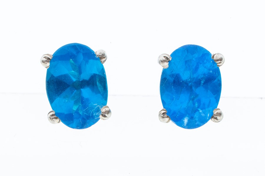 A pair of neon apatite and silver stud earrings, claw set, size approx 6 x 4mm, post and scroll