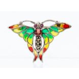 A silver and plique a jour brooch in the form of a small butterfly, the body set with ruby and
