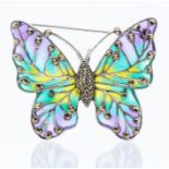 A silver and plique a jour butterfly pendant/brooch, the body and wings set with marcasite,