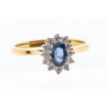 A sapphire and diamond 18ct yellow gold ring, the oval claw set sapphire weighing approx 0.50ct,