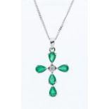 An emerald and diamond 14ct white gold cross, comprising five pear cut emeralds, total emerald