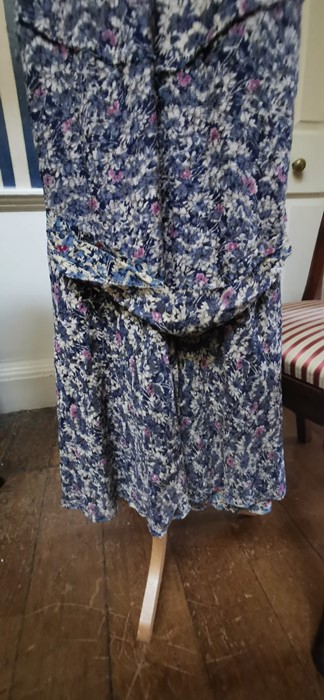 A 1930s blue floral dress with a beige/cream and cerise pink floral design on a blue background. - Image 2 of 3