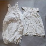 Two Christening gowns; one with fine cotton lawn gown heavily embroidered in a flower and foliage