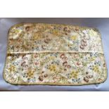 A piece of oyster cream silk brocaded with colourful meandering floral sprays consisting of three