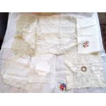 A silk / lace point de gaze handkerchief with an embroidered roundall in the centre, another lace