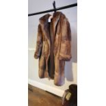 WITHDRAWN A musquash fur coat from the early 1950s in a tawny brown colour the lining is damaged