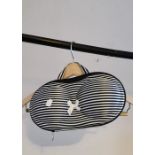 A novelty bag in the shape of a bikini top in black and white stripe and matching handle with a bow
