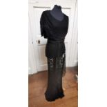 A black silk crepe early 1930s dress with a black lace inserted modesty vest with a belt.