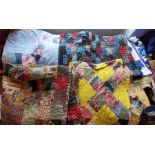 A very colourful patchwork padded quilt with a floral green and red lining, patchwork, late