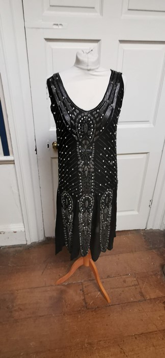 A black beaded Art Deco 1920s dress, this iconic dress is embellished in silver and black bugle