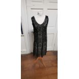 A black beaded Art Deco 1920s dress, this iconic dress is embellished in silver and black bugle