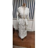 An early 1900s white cotton day dress with a crocheted sailor collar and is inserted with lace