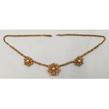 An 18ct. gold and cultured pearl necklace, having three graduated flower form mounts, each set