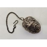 A late 19th century continental silver egg form tea infuser, repousse shell and 'C' scrolls, with