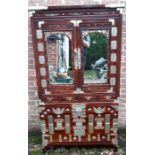 An early 20th century Chinese mirrored cabinet inlaid with abalone bats with bevelled plate mirrors