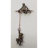 A continental white metal, pearl and paste set novelty "monkey acrobats" brooch, (white metal