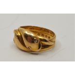 An 18ct. gold and diamond set 'snake' ring, fashioned from two bands as twin intertwined snakes,