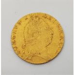 A 1797 George III gold spade guinea, obv. fifth laureate head, rev. spade shaped shield. Grade as