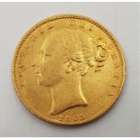 An 1863 Victoria "Young bust" gold sovereign, rev. shield.