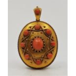 A Victorian precious yellow metal and pink coral set mourning pendant, having domed oval front set