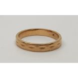 An 18ct. gold faceted band. (3.6g) Ring size: UK O -