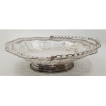 A Victorian silver swing handled basket, Henry Holland, London 1856. of undulating ovoid form, the