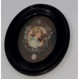 An early 20th cent portrait miniature of a girl with emboossed silver mount