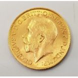 A 1911 George V gold sovereign, London mint.