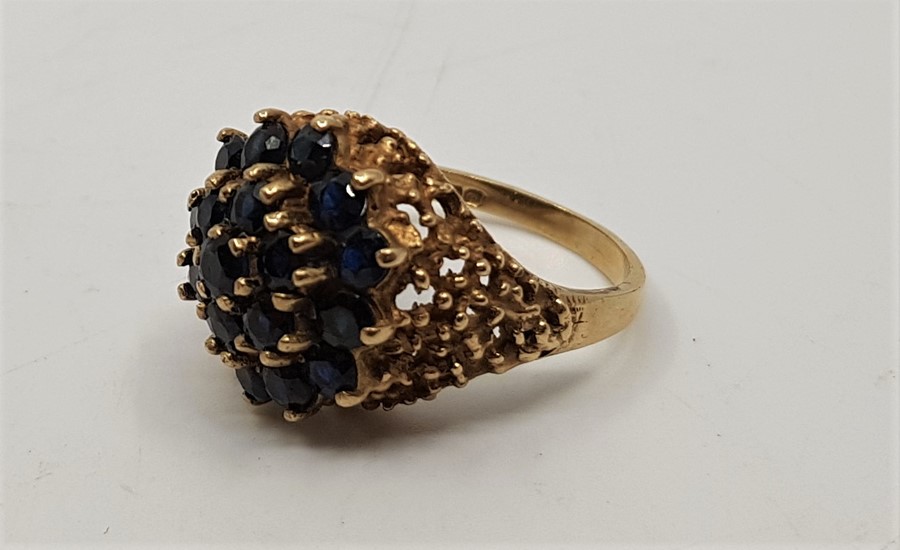 A 9ct, gold sapphire cluster ring, set numerous round cut sapphires with pierced oraganic form