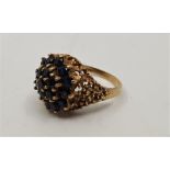 A 9ct, gold sapphire cluster ring, set numerous round cut sapphires with pierced oraganic form
