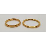 Two 22ct. gold bands. (total weight 6.4g). (2)