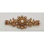 A precious yellow metal, diamond and cultured pearl set floral brooch, central flower form mount set