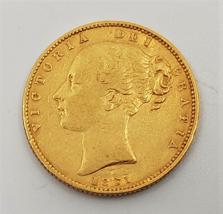 An 1861 Victoria "Young bust" gold sovereign, rev. shield.