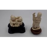 Two early 20th Japnese carved Ivory Netsuke figures with original wooden stands