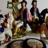 A collection of Staffordshire figures and potlids including named figures Dick Turpin and Dog trap