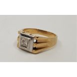 A gentleman's two-tone 9ct. gold and diamond ring, flush set single round brilliant cut diamond to