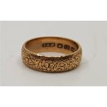 An 18ct. gold band, engraved foliate scrolls to exterior, assayed Birmingham 1906, (4.6g), in