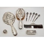 A collection of Art Nouveau silver mounted vanity items, to include: a hand mirror and hair brush,