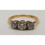 An 18ct. gold three stone diamond ring, set three graduated round cut diamonds (centre stone approx.