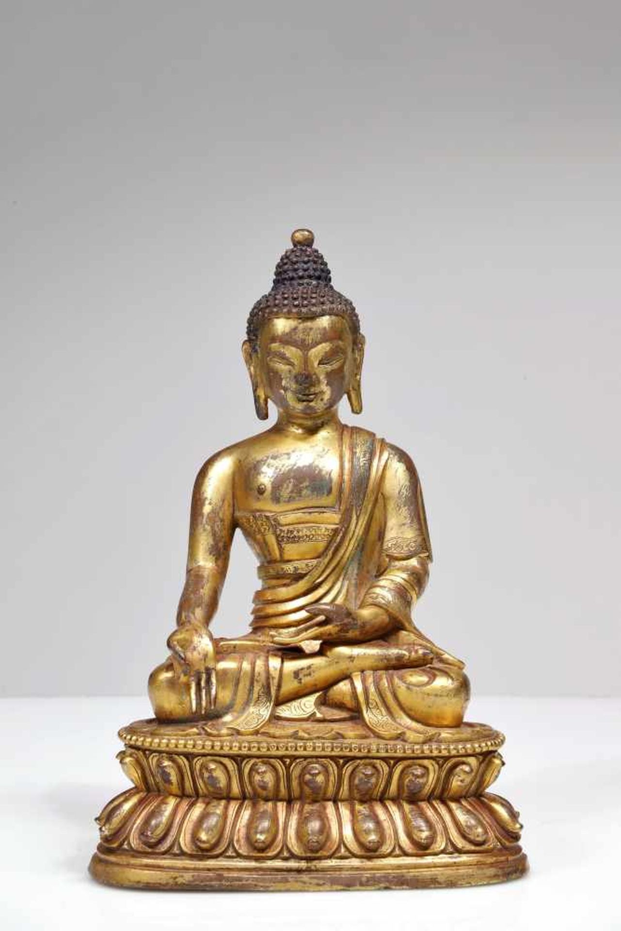 A BRONZE GILDED BUDDHA