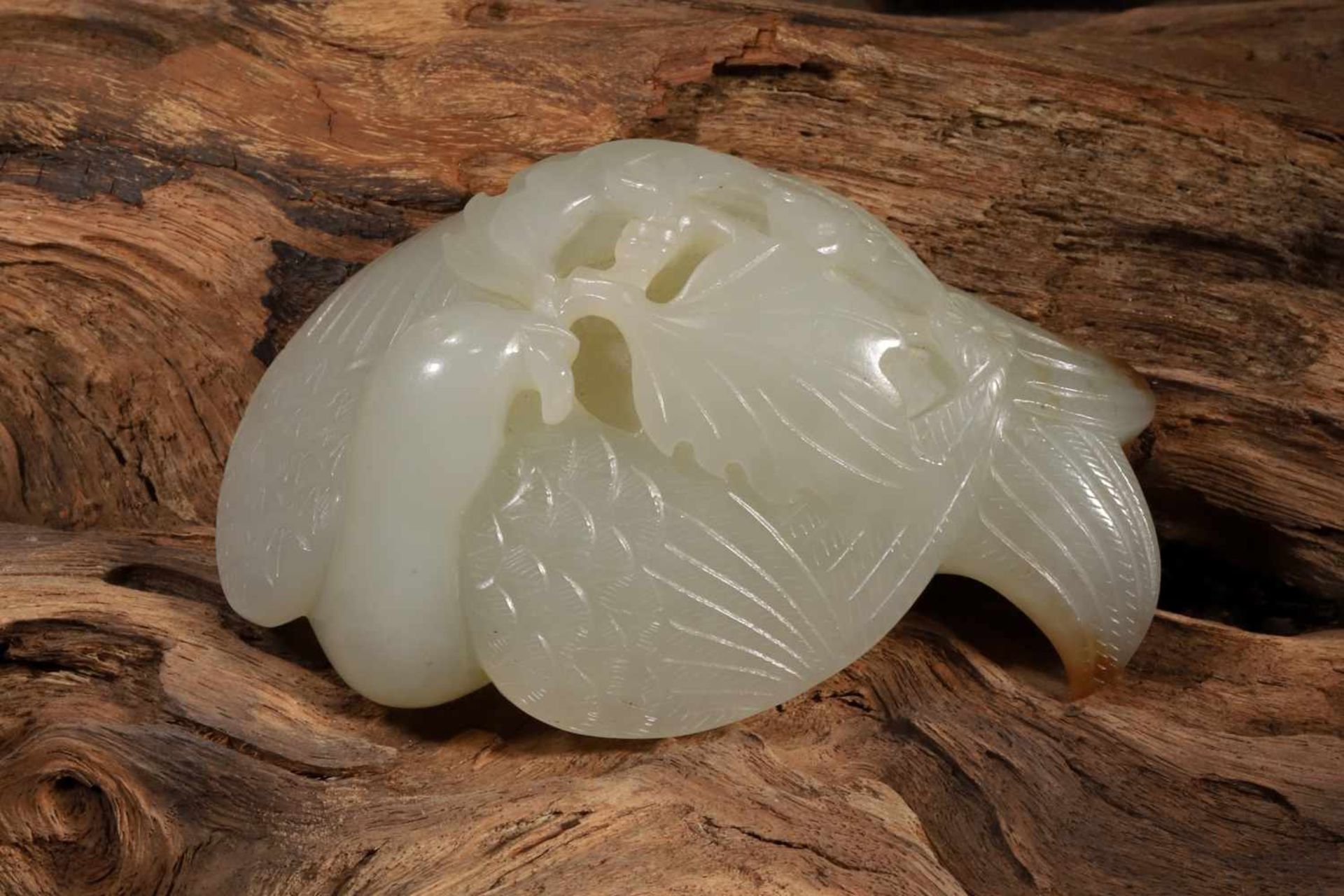 A HETIAN JADE CARVING DEPICTING A PHOENIX INHABITING A BRANCH