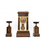 Early 19th century eraCharles X mantlepiece garnitureComposed of a portico clock and two rosewood