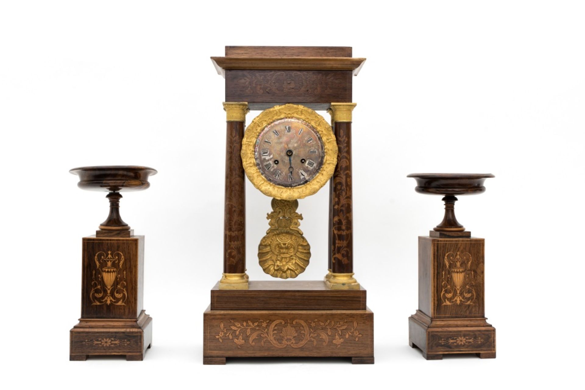 Early 19th century eraCharles X mantlepiece garnitureComposed of a portico clock and two rosewood