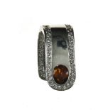 Pendant 18 kt white gold, set with an orange oval citrine cabochon (one dent) with a border of tiny