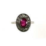 Ruby ring 18 kt white gold, set with a +/- ct oval ruby surrounded by small old-cut diamonds.