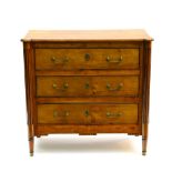 19th century work Commode, Lemonwood and lemonwood veneer, with three drawers and fluted legs.