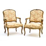 18th century work Pair of Louis XV armchairs, Natural wood, carved with flowers and leaves.