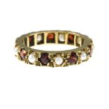 Victorian wedding band Yellow gold set with garnets and pearls. Late 19th century English work.