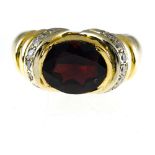 Garnet ring 14 kt yellow gold, set with an oval garnet and 2 rows of small brilliants. Hallmark: 14